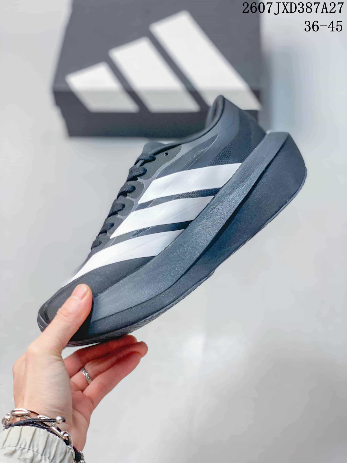 Side profile of the black and white sneaker showing layered side stripes and a thick dark sole.