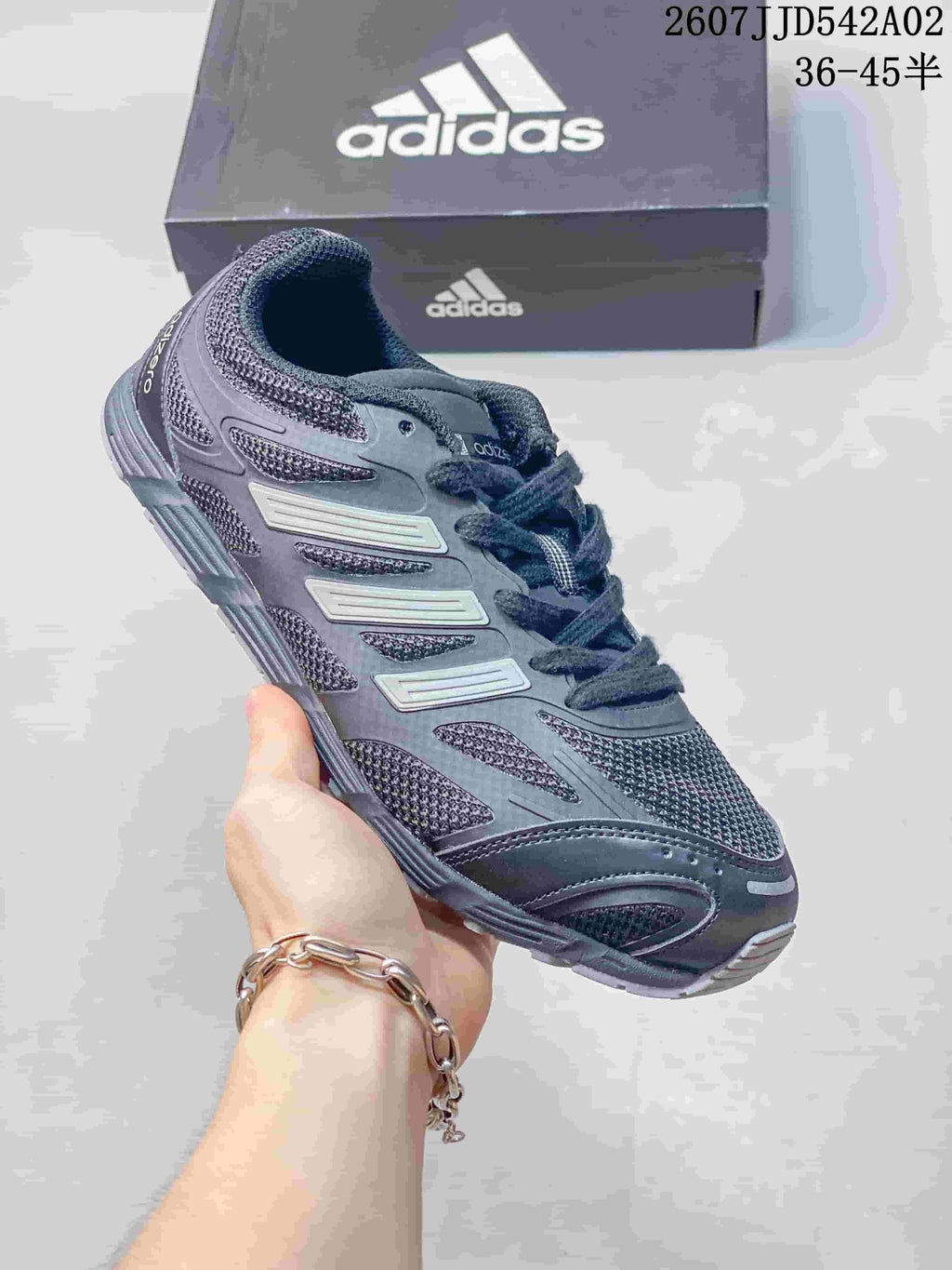 Charcoal Adidas Adizero-style sneaker with dark laces and layered side details