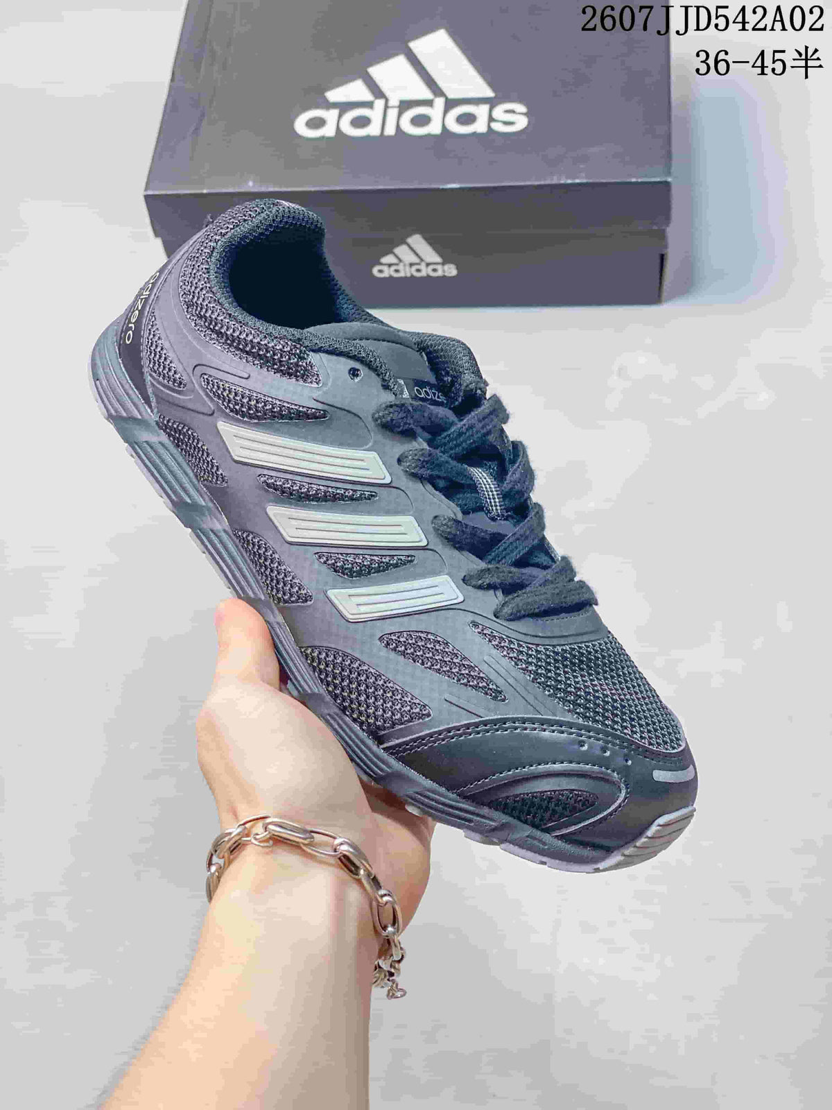 Charcoal Adidas Adizero-style sneaker with dark laces and layered side details