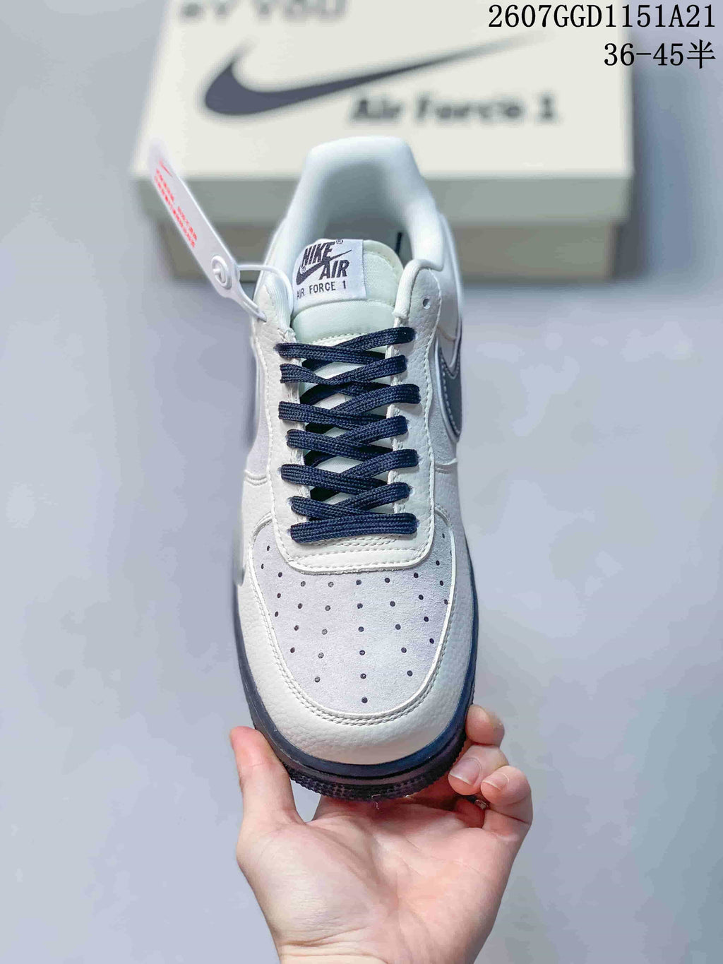 Top view showing the perforated white toe box, navy laces, and Air Force 1 tongue label.