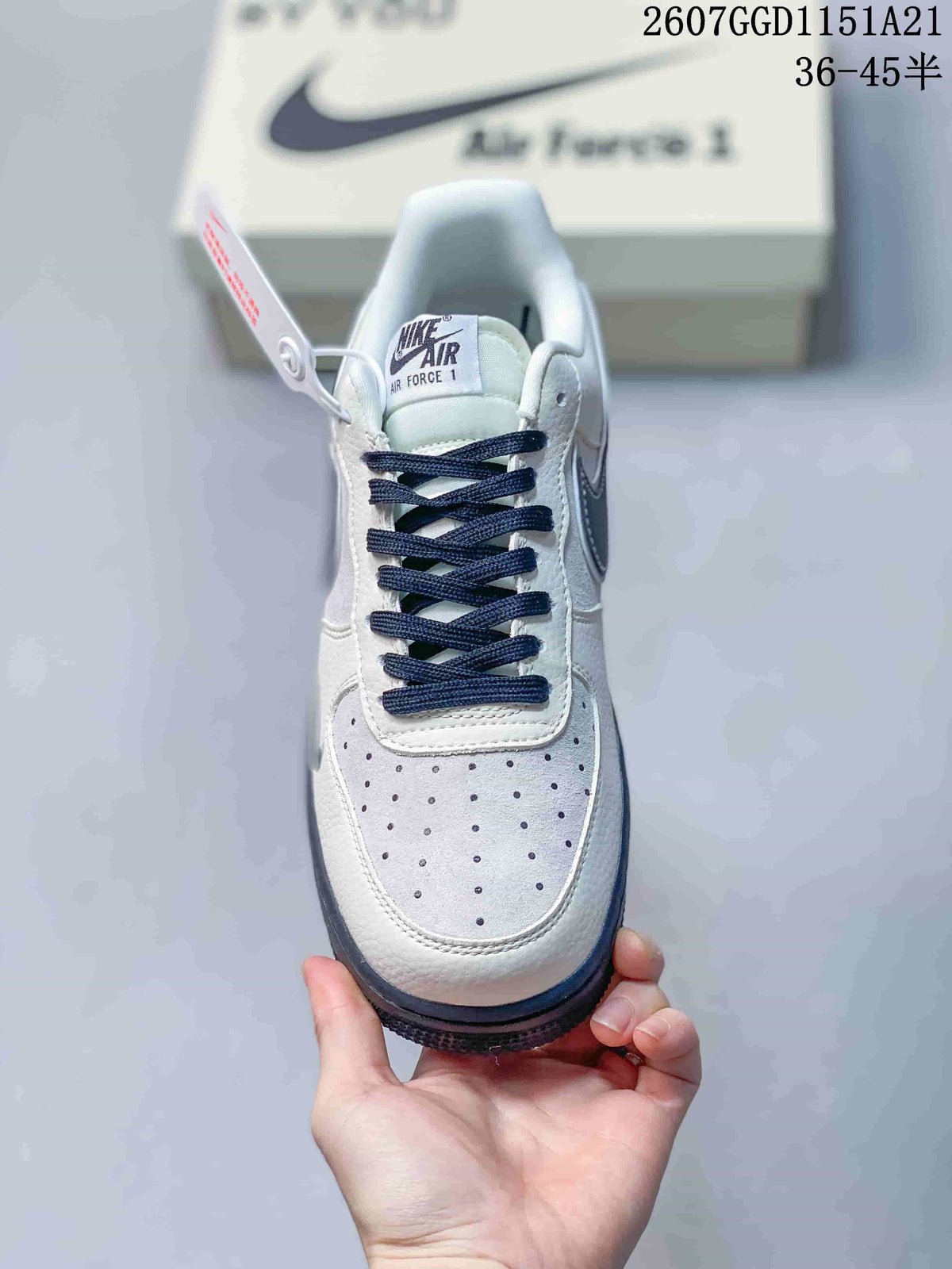 Top view showing the perforated white toe box, navy laces, and Air Force 1 tongue label.