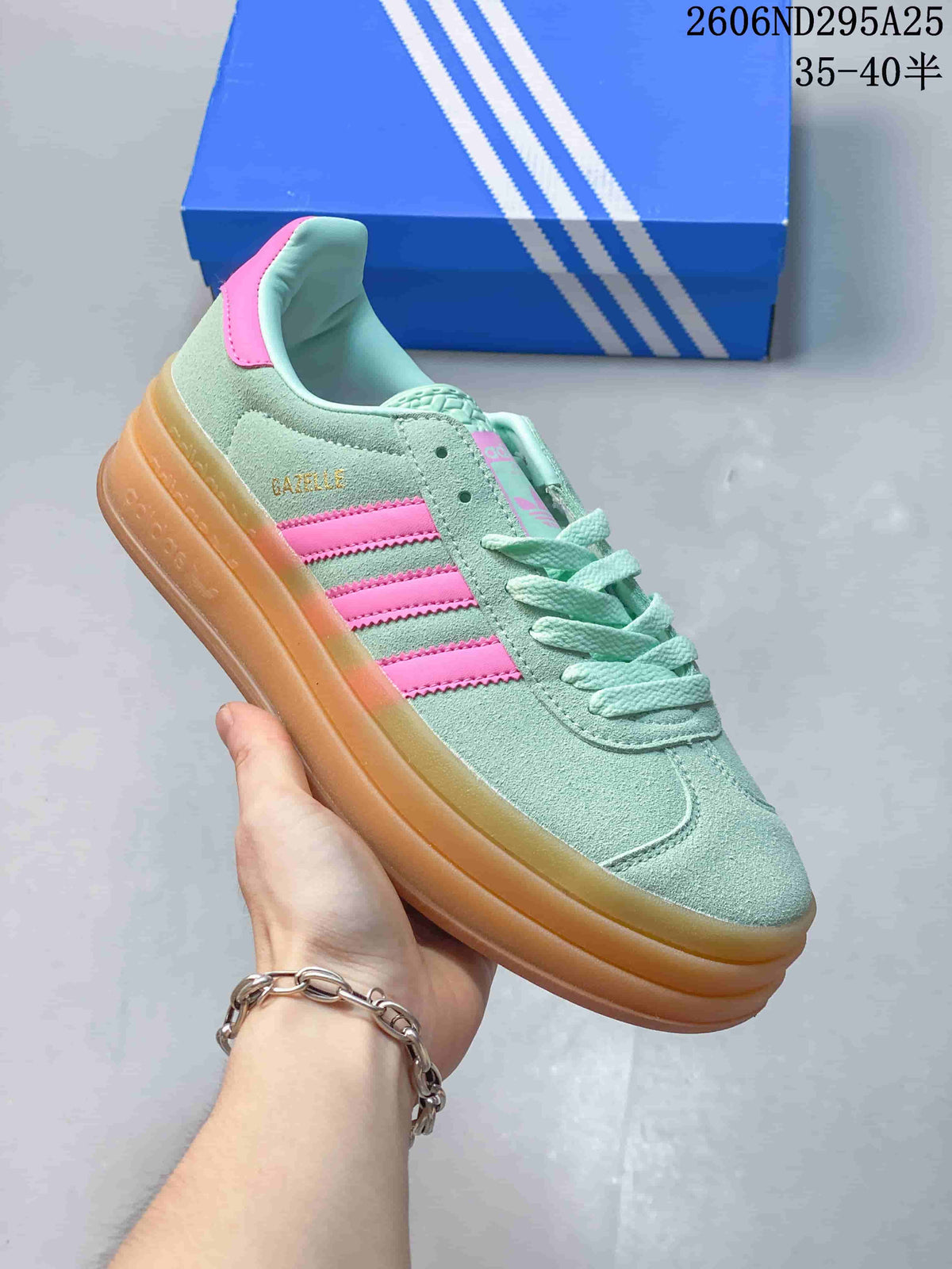 Mint green low-top sneaker with pink stripes and accents, mint laces, and a gum-colored platform sole