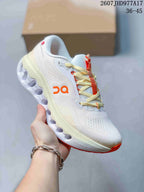 Side view of a white On Cloudtilt sneaker with orange accents and a light sculpted outsole.