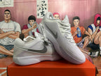 Pair of white and pale purple Nike basketball shoes shown at an angle