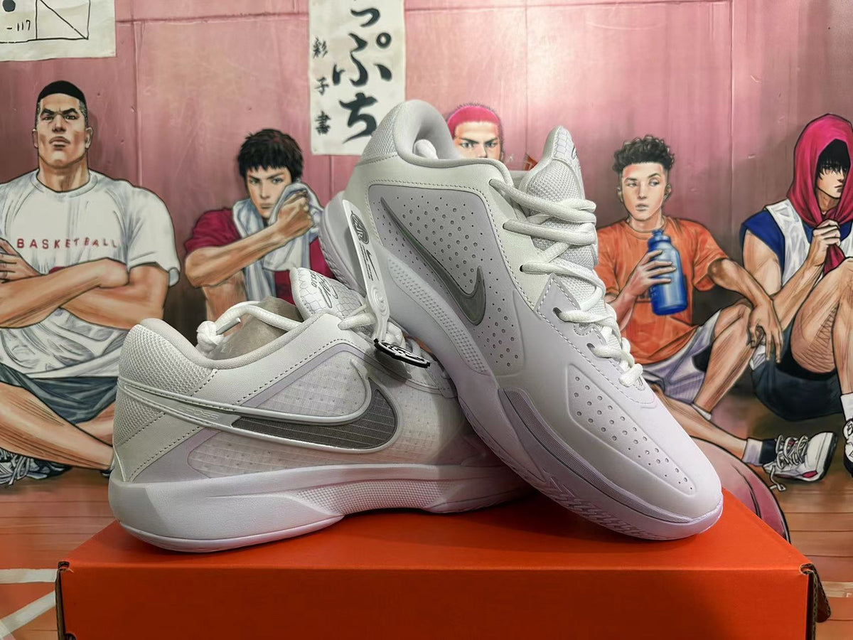 Pair of white and pale purple Nike basketball shoes shown at an angle