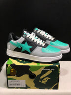 Pair of BAPE Bape Sta sneakers displayed on a camouflage shoebox.