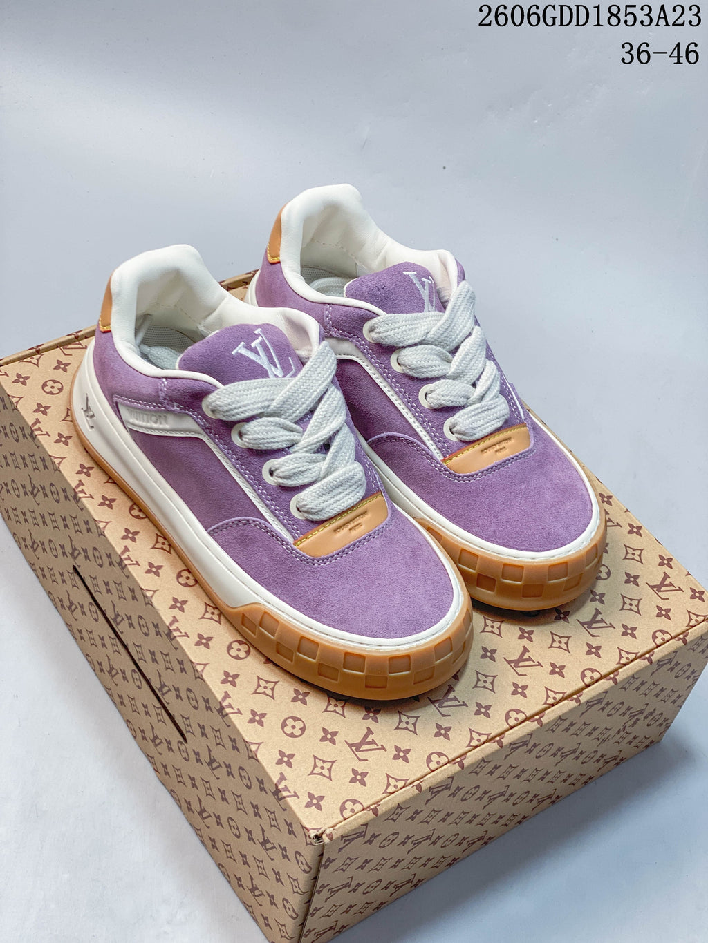 Pair of purple Louis Vuitton Tilted low-top sneakers with white laces and gum-colored outsoles.