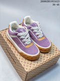 Pair of purple Louis Vuitton Tilted low-top sneakers with white laces and gum-colored outsoles.