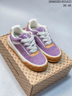 Pair of purple Louis Vuitton Tilted low-top sneakers with white laces and gum-colored outsoles.