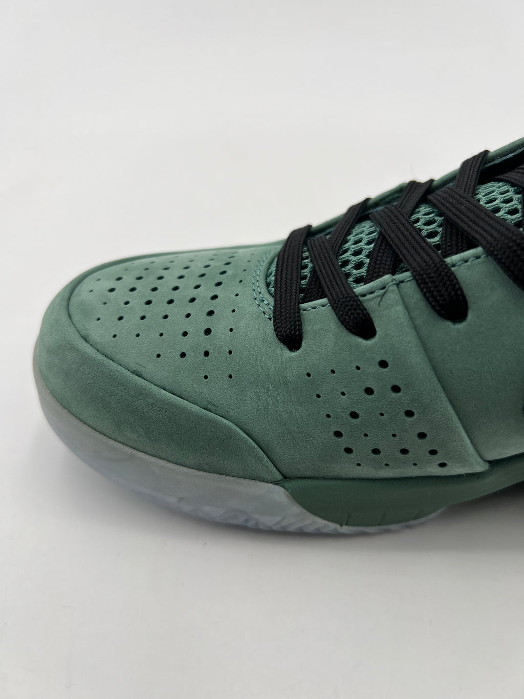 Close-up of the perforated green toe and black laces