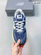Top view showing the mesh toe area, white laces, tongue branding, and layered panels.