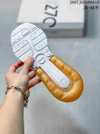 Outsole view showing white tread sections, gold-toned heel sections, and Air Max branding.