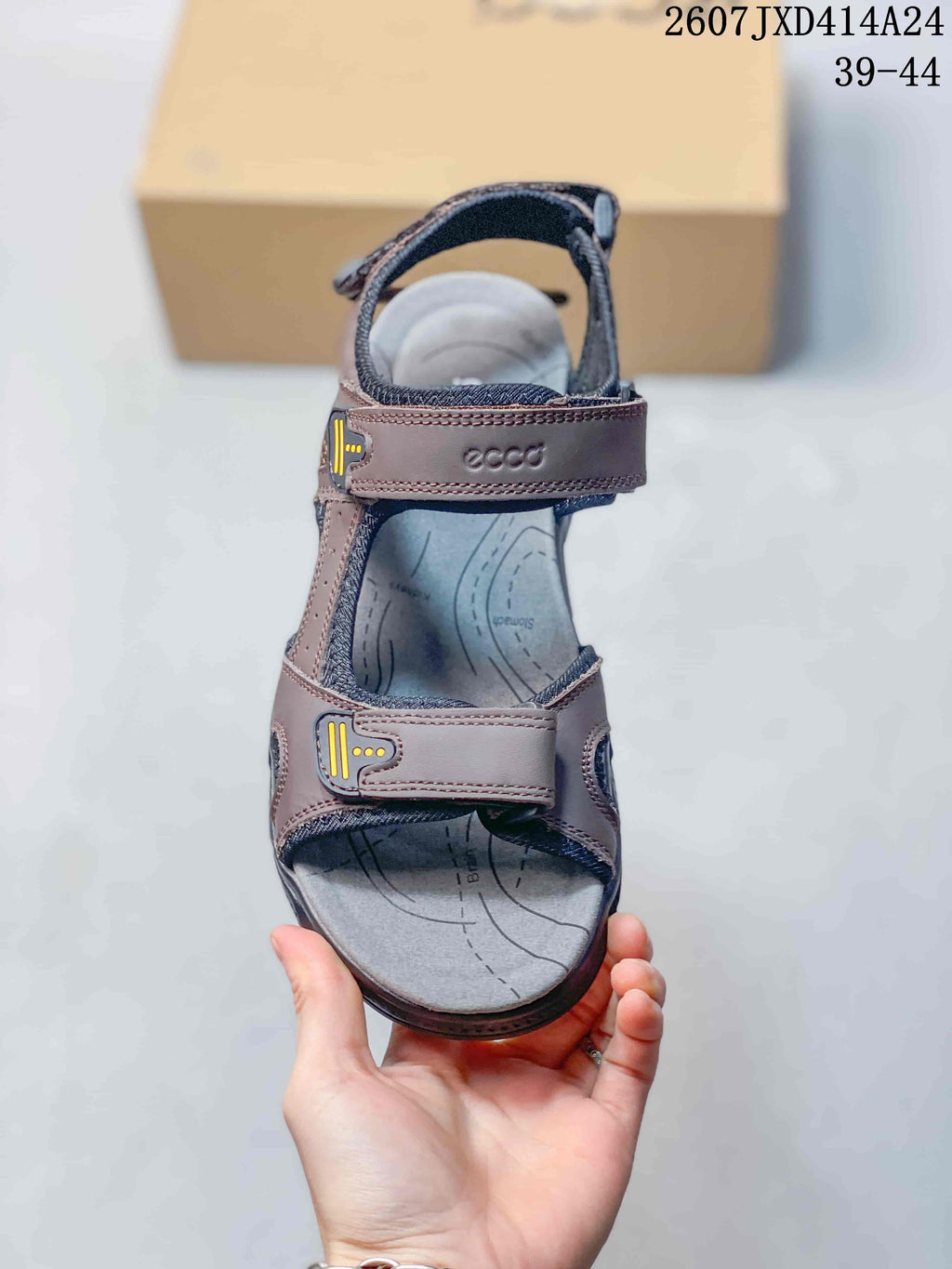 Top view of a single brown sandal showing the open toe, adjustable straps, and contoured footbed.