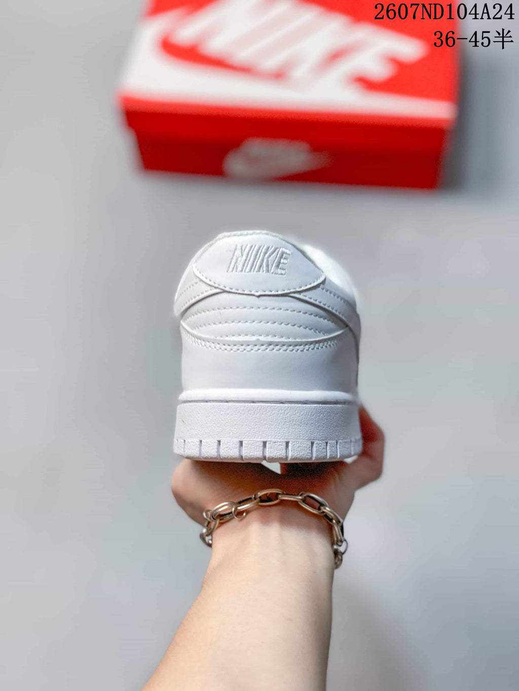 Rear view of a white low-top sneaker showing the padded heel and outsole edge.