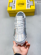 Top view of the sneaker showing the white laces, tongue label and reflective upper.