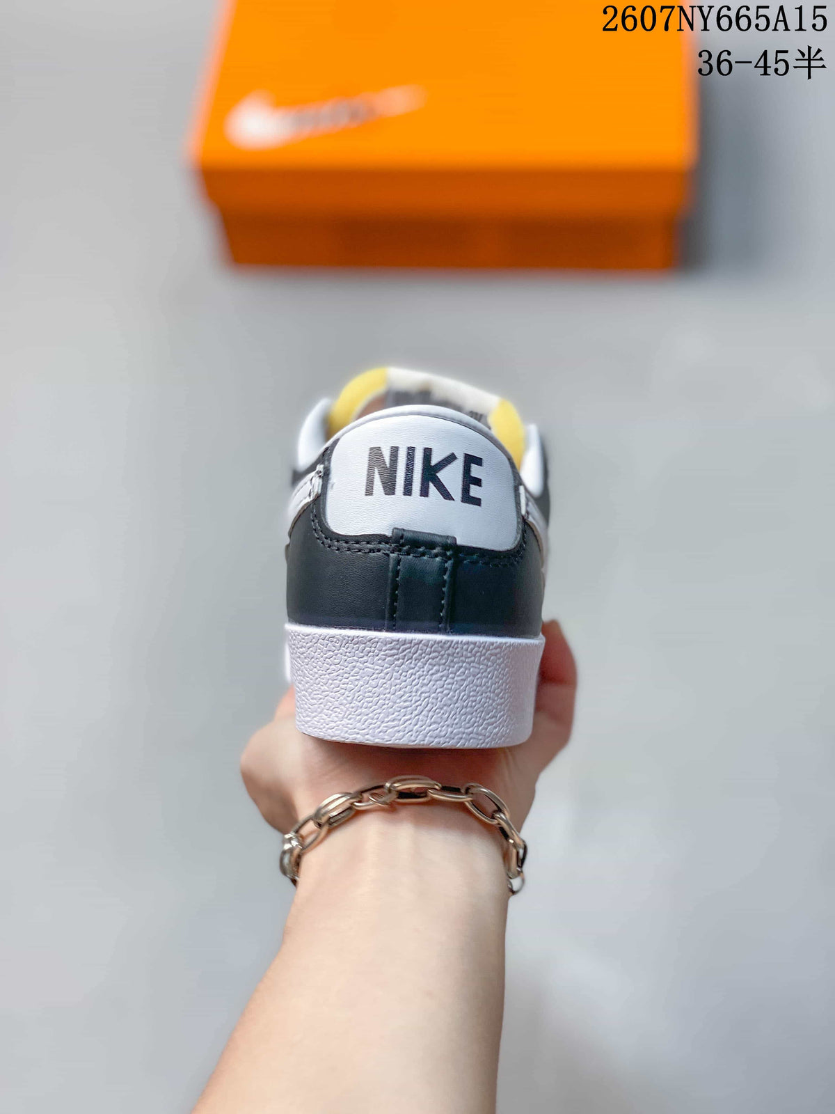 Rear view of the sneaker showing black heel panels, white midsoles, and Nike branding.