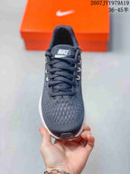 Top view showing the lace-up dark gray upper, patterned forefoot, and Nike tongue label.