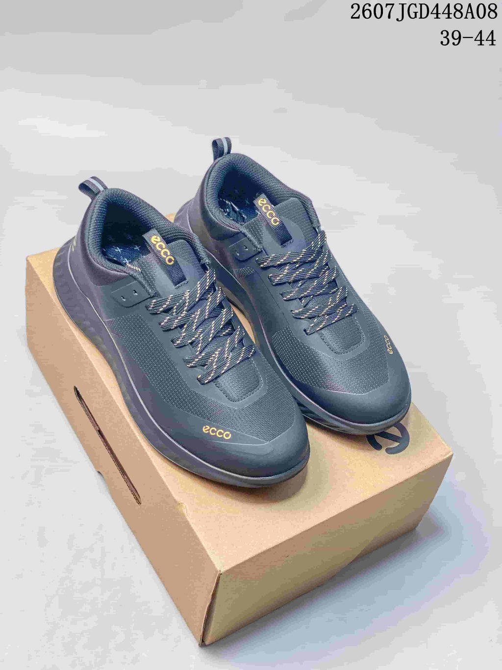 Pair of dark gray ECCO lace-up sneakers displayed on a shoe box, with product code 2607JGD448A08 and size range 39–44 visible above.
