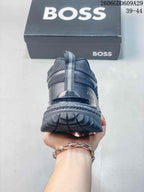 Rear view of a gray sneaker highlighting the heel pull tab and lugged outsole.