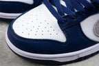 Close-up of the perforated white toe box, navy toe overlay, and layered stitching.