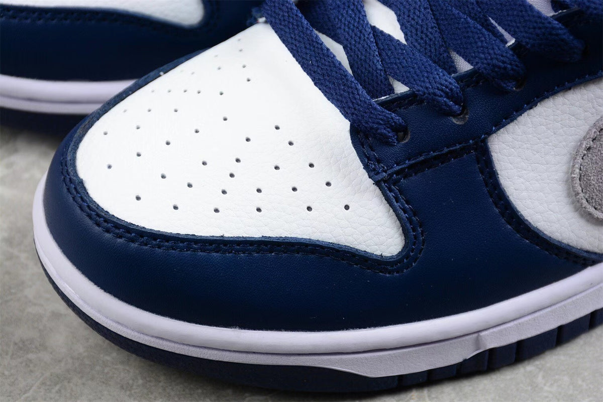 Close-up of the perforated white toe box, navy toe overlay, and layered stitching.