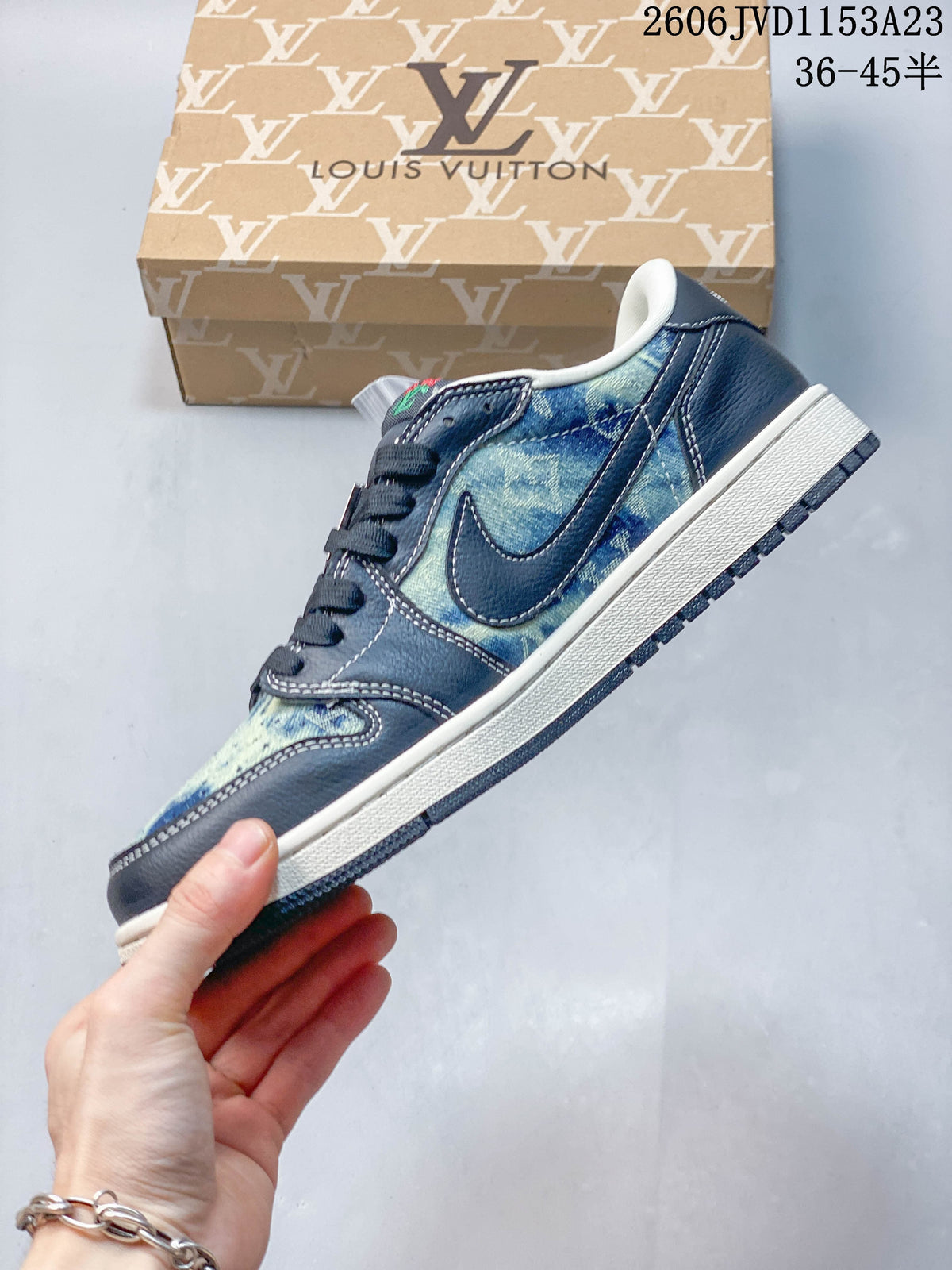 Side view of a low-top sneaker with blue patterned panels, navy overlays, and a light-colored midsole.