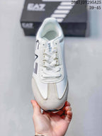 Top view of the sneaker showing white laces, padded collar, beige toe panels, and side branding.