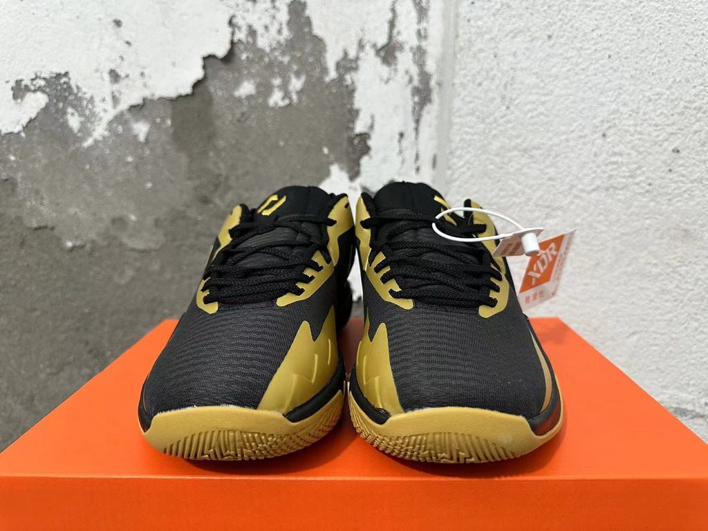 Front view showing the black laces and gold accents on Nike basketball sneakers