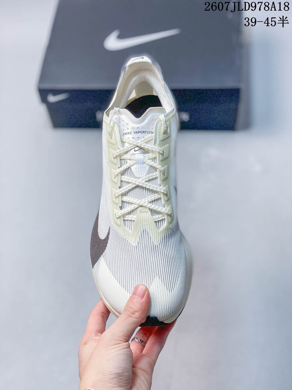 Top view of the white Nike Vaporfly shoe showing the lace system, tongue branding and textured upper.