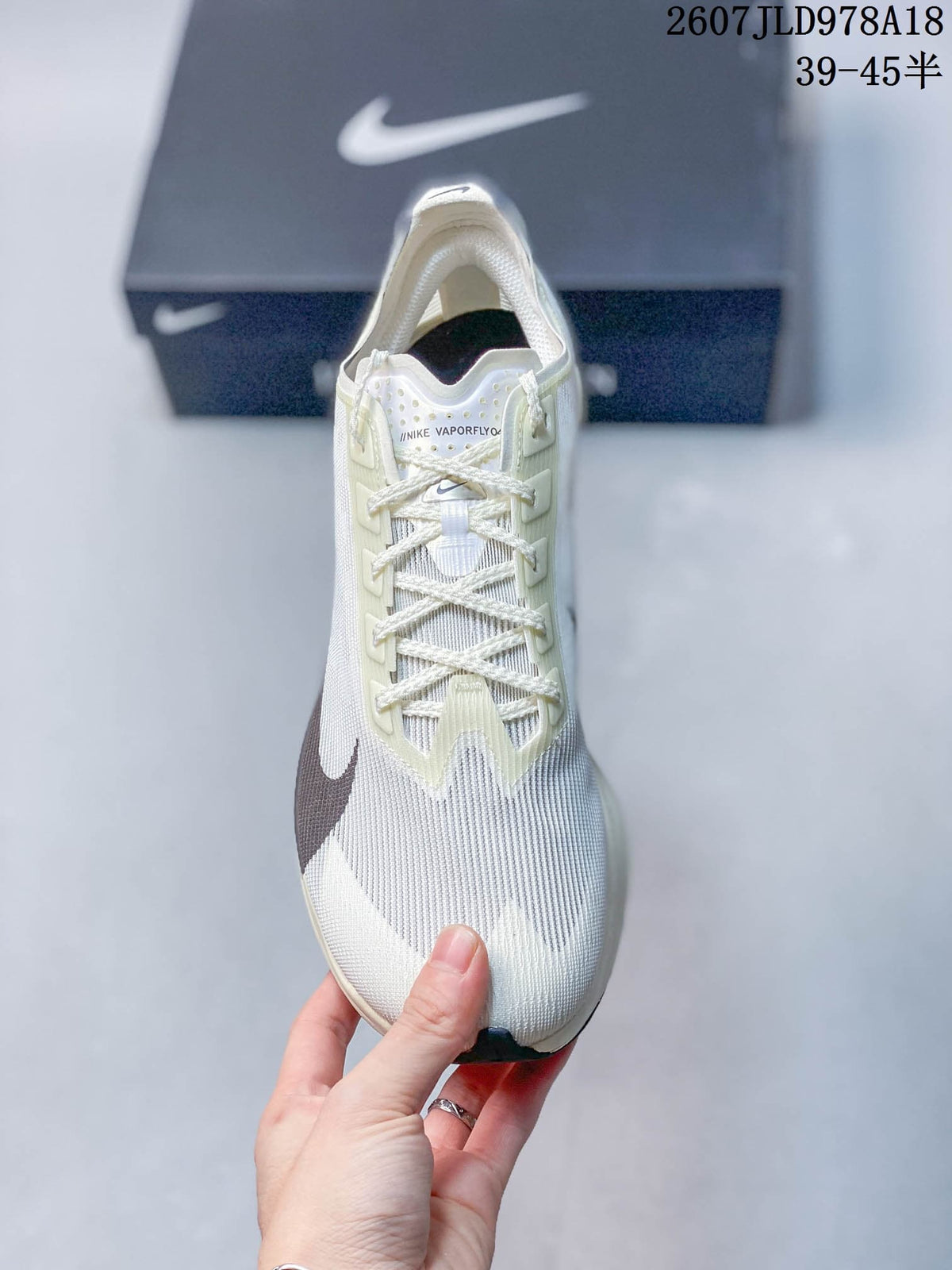 Top view of the white Nike Vaporfly shoe showing the lace system, tongue branding and textured upper.