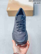 Top view of a dark gray lace-up running shoe showing the textured toe area and tongue; overlay text shows 2607JHD236A26 and 36–45.5.