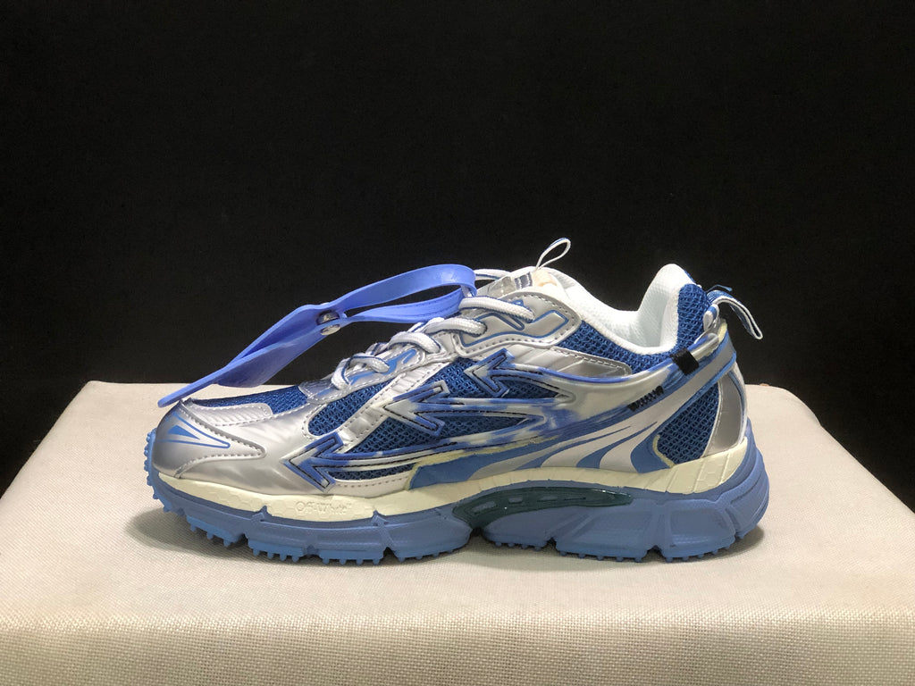 Outer side profile showing the large arrow detail, blue mesh panels, and heel branding.