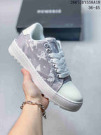 Light gray NUMERIS low-top sneaker with white laces, white toe cap and abstract camouflage-style panels; image shows size range 36-45.