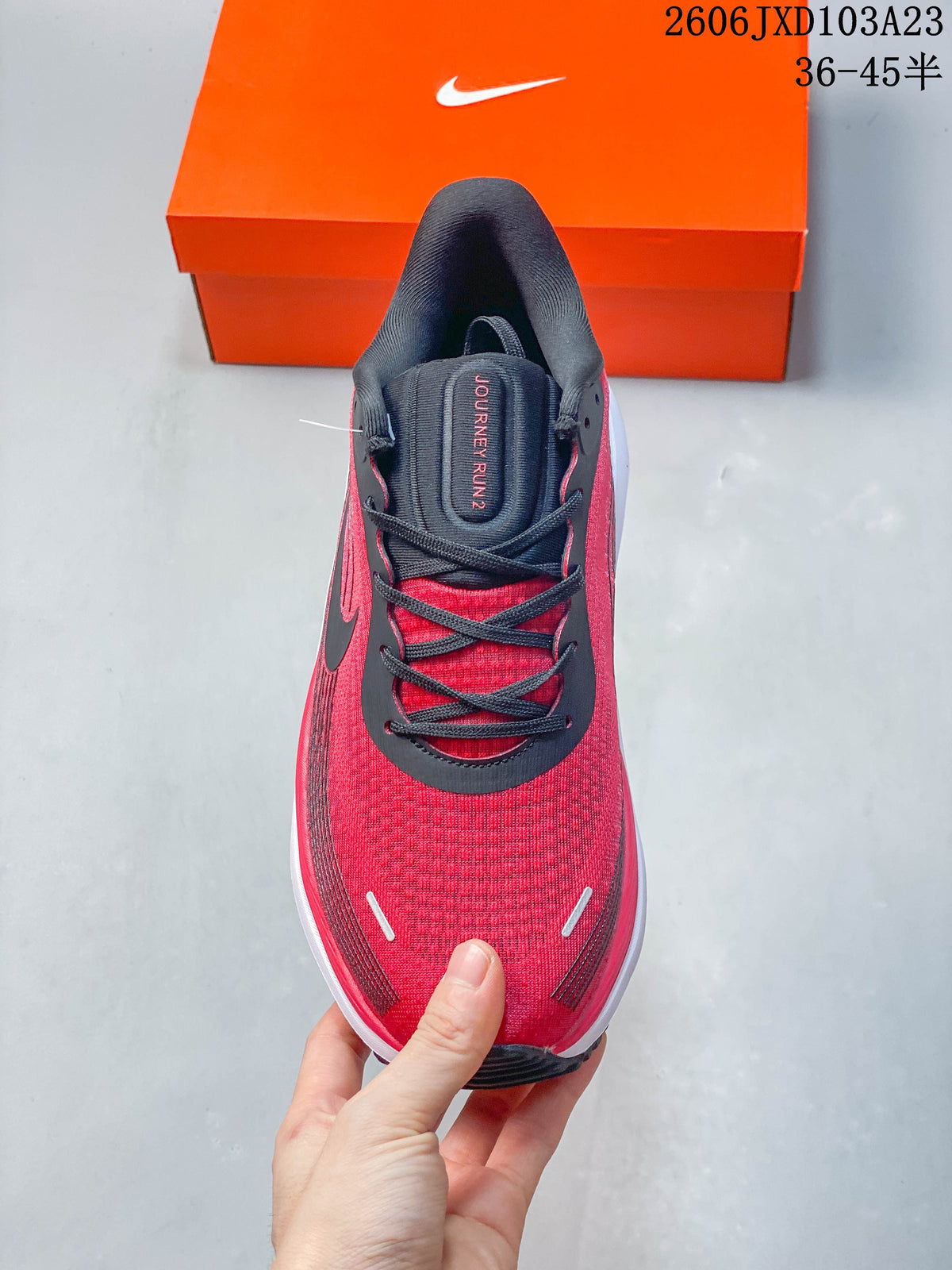 Top view showing the red upper, black laces, and padded collar of a running shoe