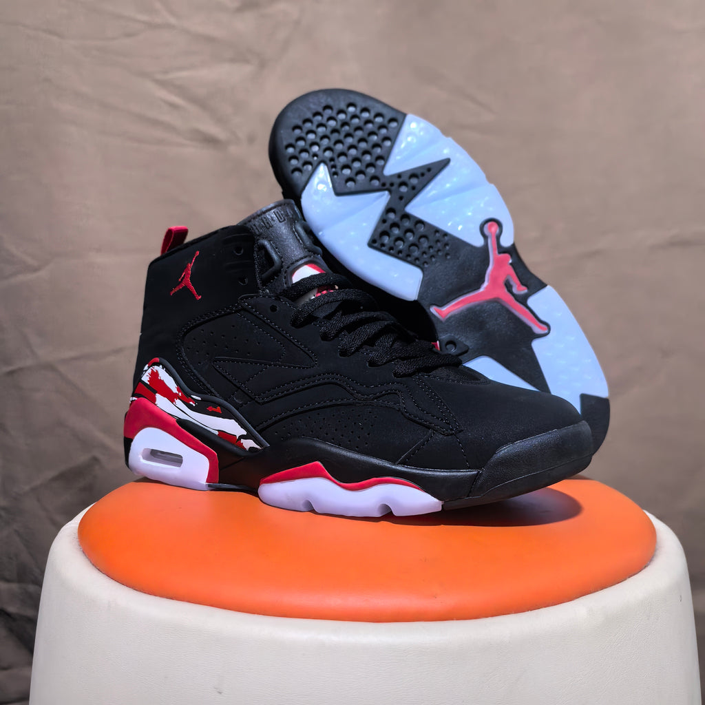 Black and red high-top sneaker with outsole visible beside it