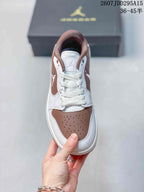 Top view of the sneaker showing white laces, brown trim, a perforated brown toe box, and a Jordan tongue mark.