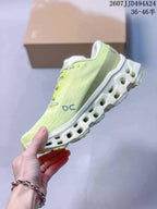 Side view of the sneaker showing On branding, a pale lime green upper, and the white open-section outsole.