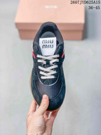 Top view showing the black sneaker, white laces, dark textured toe panel and branded tongue.