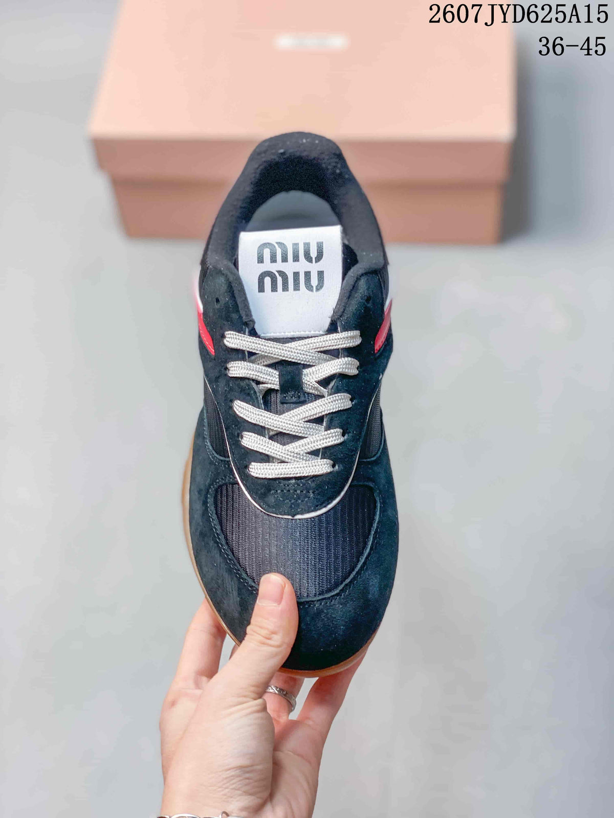 Top view showing the black sneaker, white laces, dark textured toe panel and branded tongue.