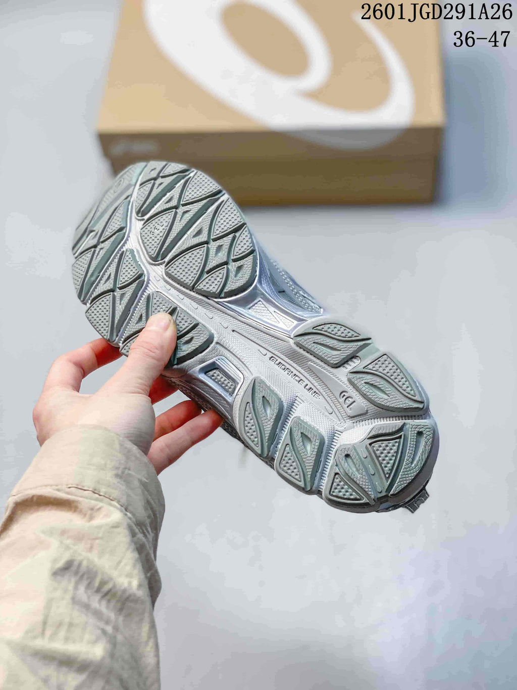 Close view of the textured gray rubber outsole and tread pattern of the sneaker.
