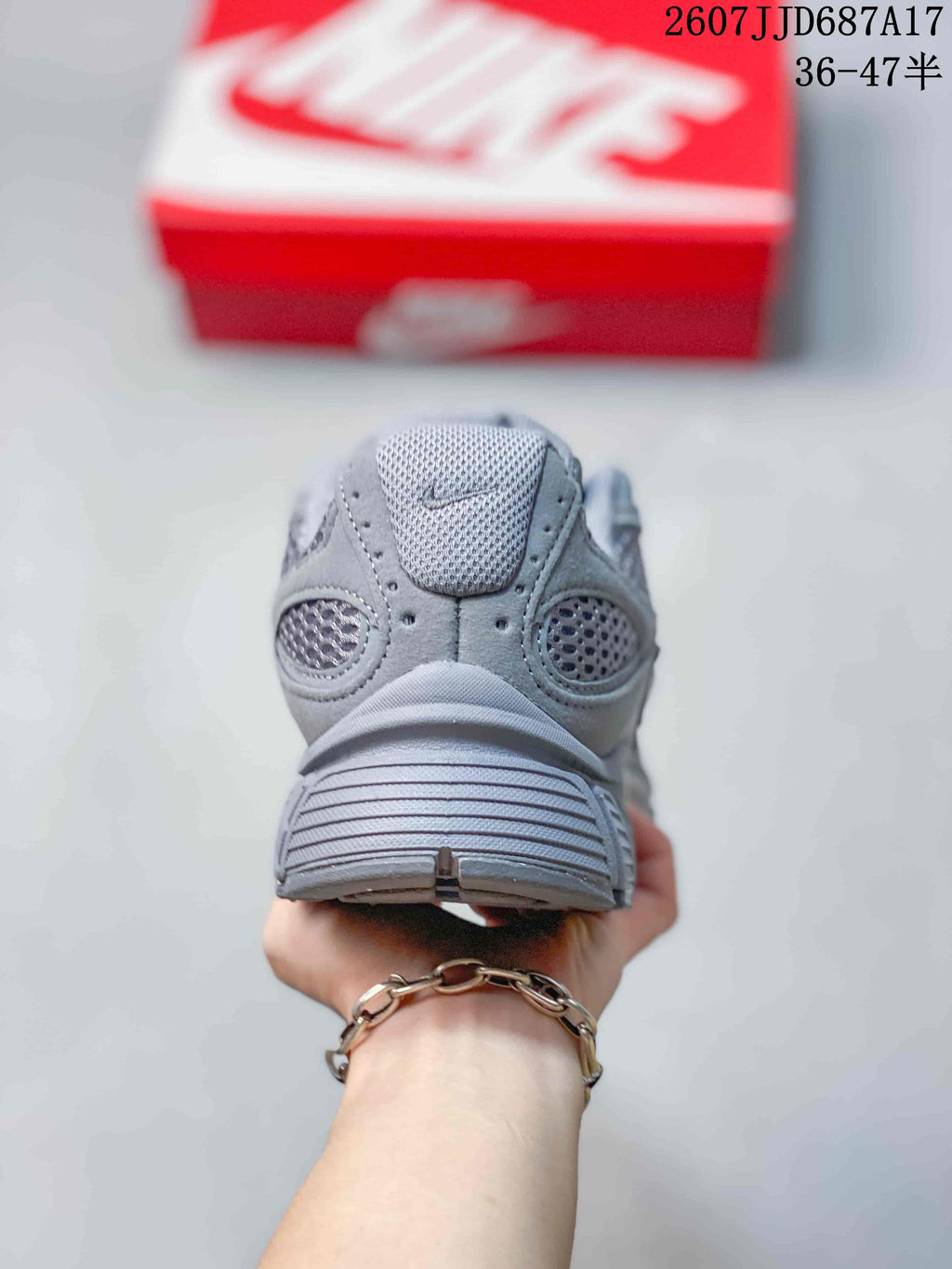 Rear view of the gray Nike V5 RNR sneaker showing the padded collar, mesh heel panels, and layered heel construction.