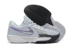 Nike tennis shoe outsole with patterned tread, shown beside the shoe's purple-accented side