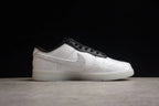 Side profile showing the white patterned upper, black lace trim, and white outsole.