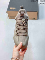 Front view showing cord lacing, toggle closure, and protective toe panel