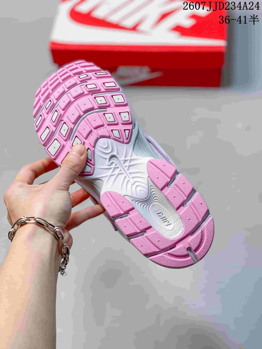 Underside view of a sneaker showing the pink-and-white segmented outsole and textured tread; overlay shows style code 2607JJD234A24 and sizes 36–41.5.