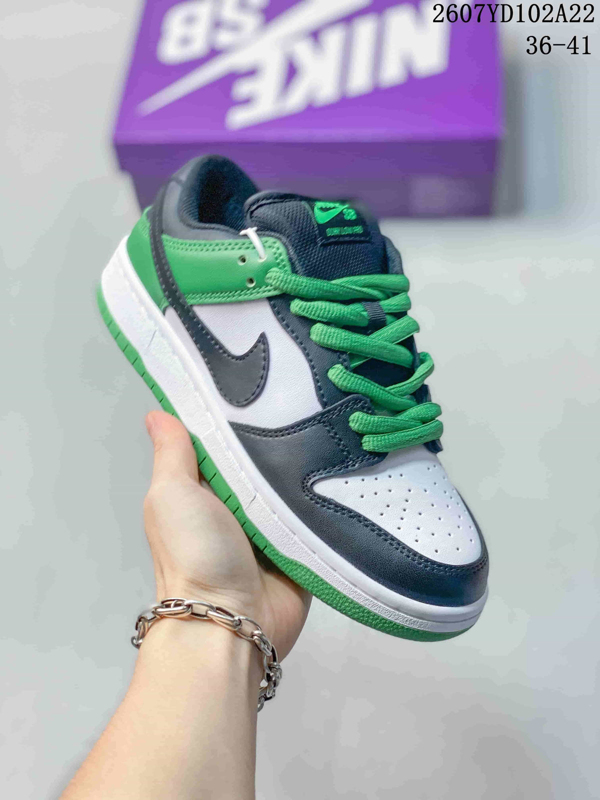 Angled side view showing the black, white and green upper, dark Swoosh, green laces and layered sole.