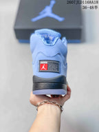 Rear view of the light blue high-top sneaker showing the Jordan heel label, dark midsole and translucent outsole edge.
