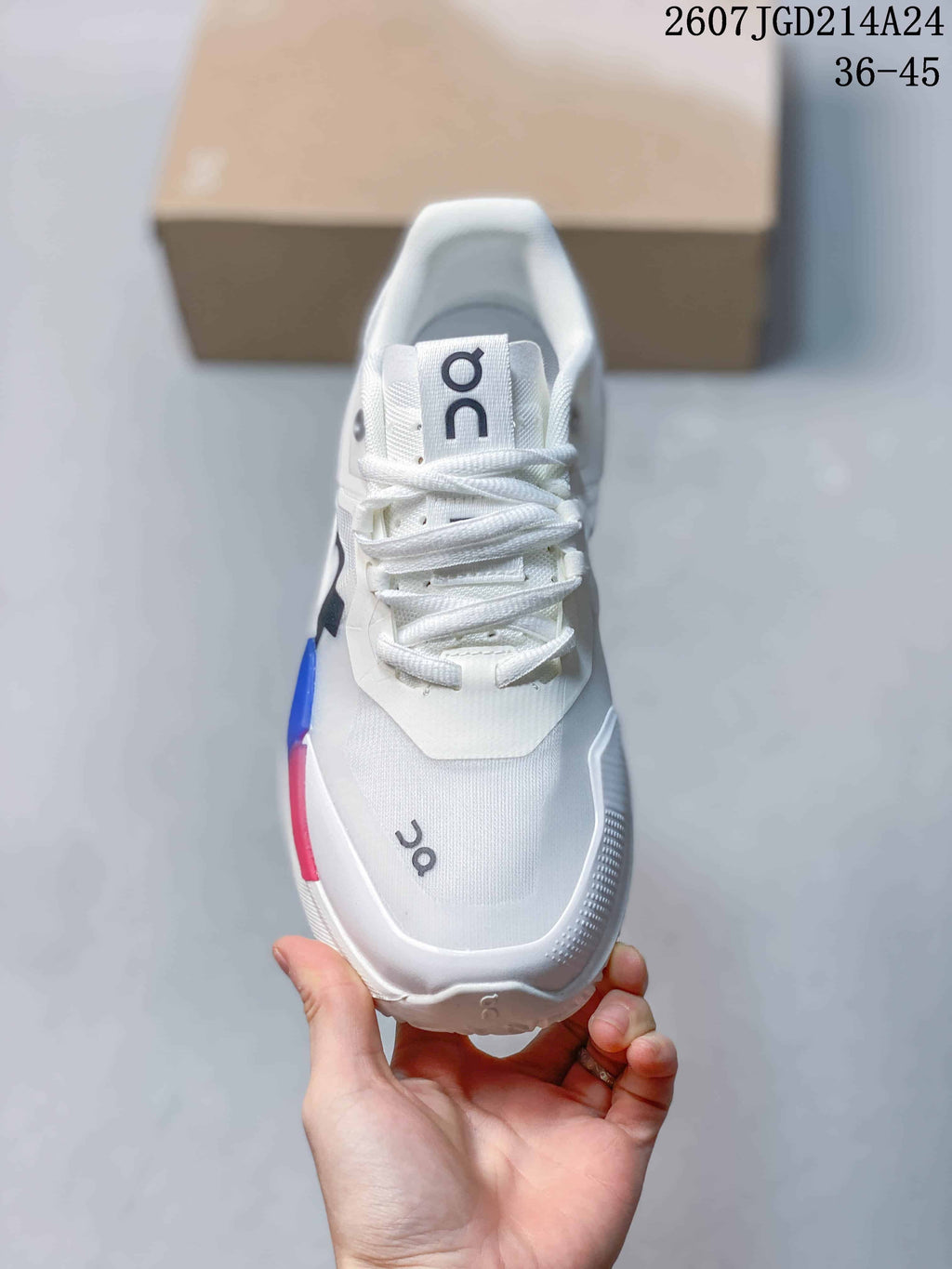 Top view of the white lace-up shoe showing the tongue, eyelets, toe box, and On branding.