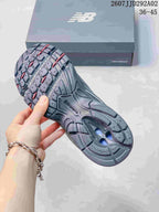 Outsole view showing the segmented tread pattern and contrasting red and blue details.