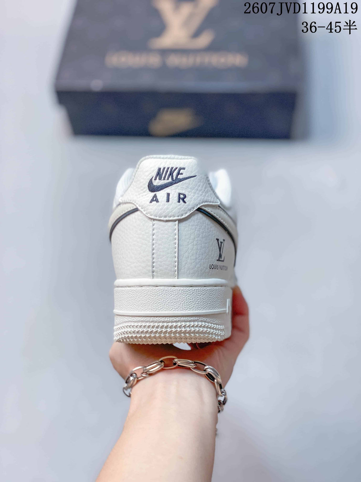 Rear view of a white sneaker showing Nike Air branding and Louis Vuitton-style side branding.